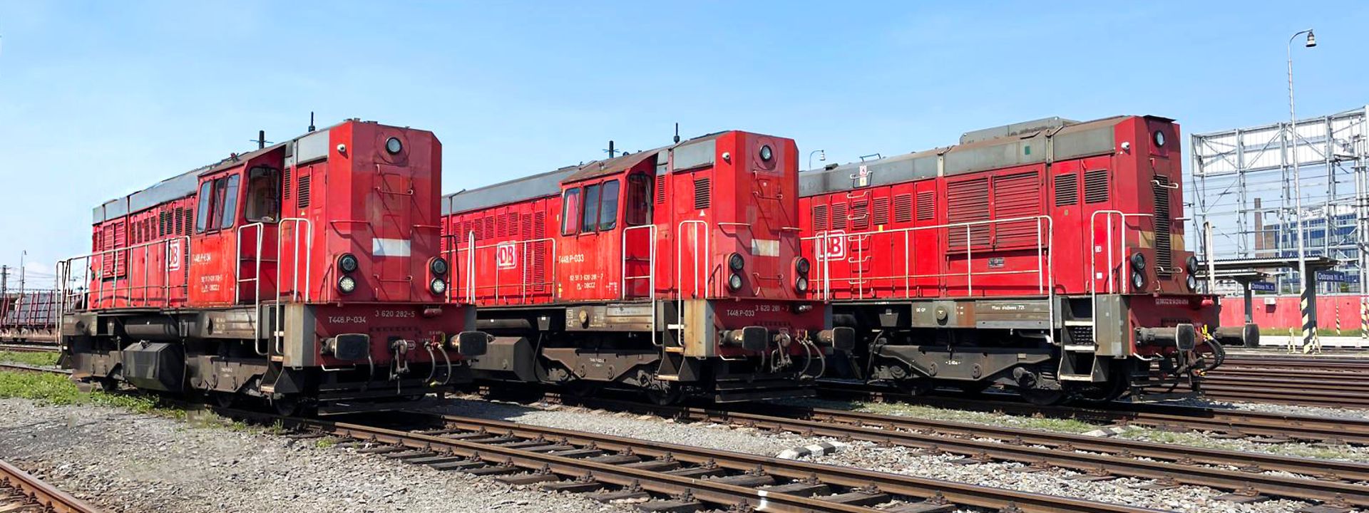 three red diesel locomotives