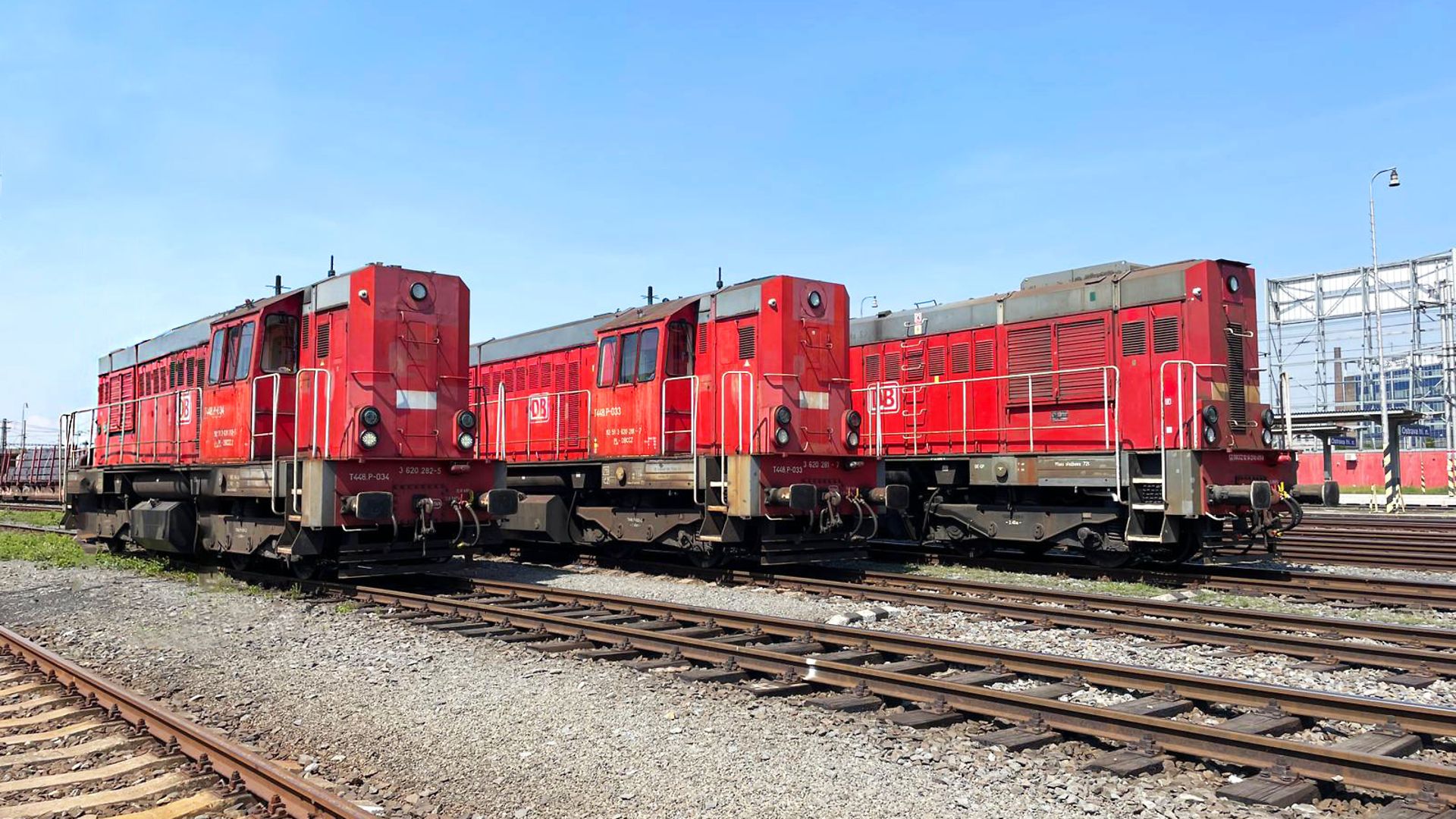 three red diesel locomotives