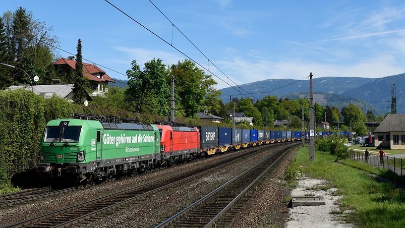 cargo train in front of mountains